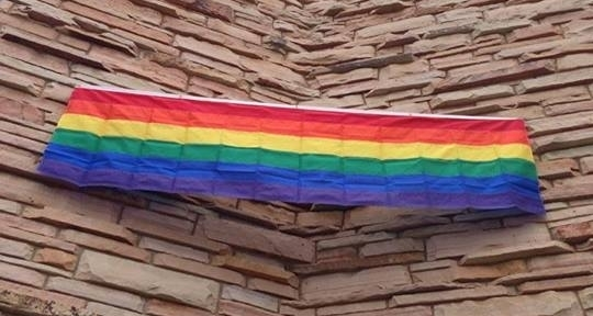 Rainbow banner stretched across the two walls of a church